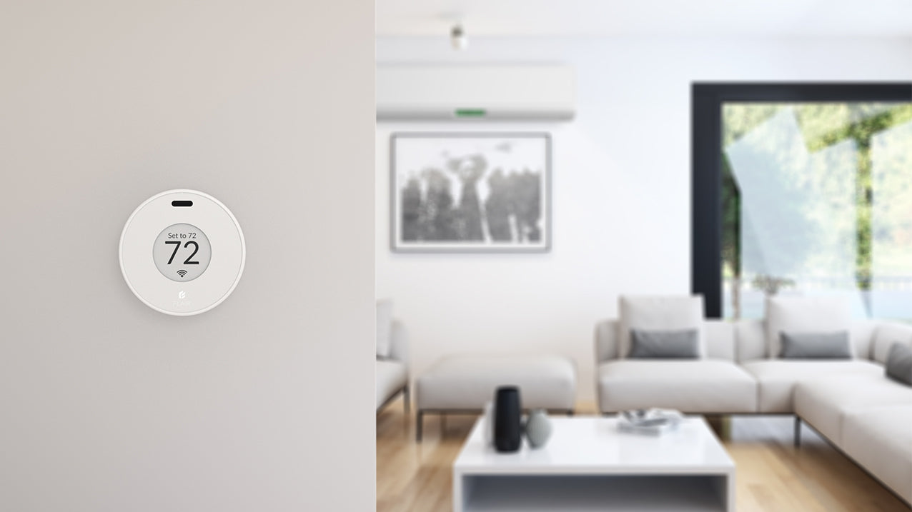 Flair Puck wireless thermostat for mini split control, mounted on wall in modern living room, set to 72 degrees.