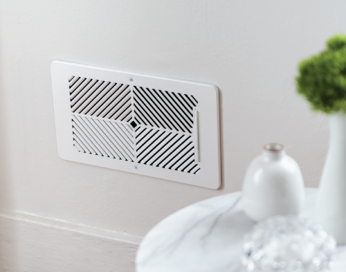 Flair Smart Vent on white wall near side table.