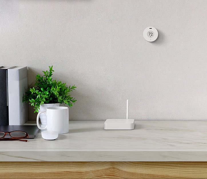Flair Bridge and Flair Puck thermostat shown together in room setup, providing smart control for mini split climate systems.