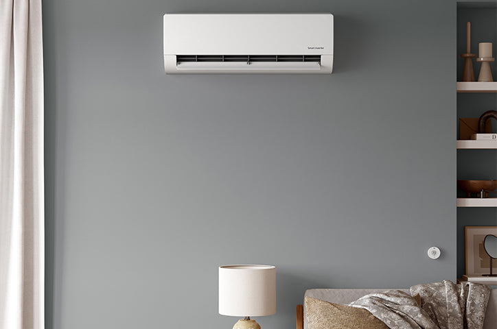 Flair Puck thermostat paired with wall-mounted mini split, shown in a living room for smart climate control.