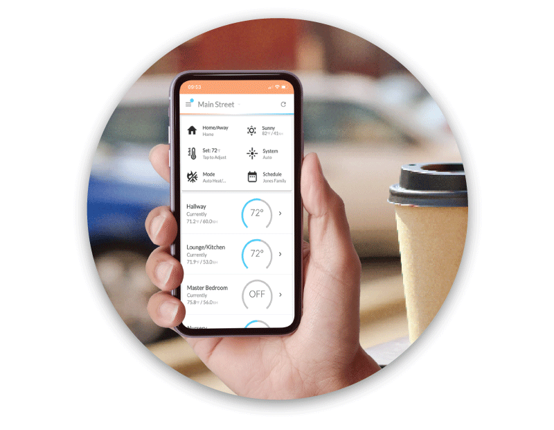 Hand holding smartphone with Flair app showing room temperatures, enabling remote climate control.