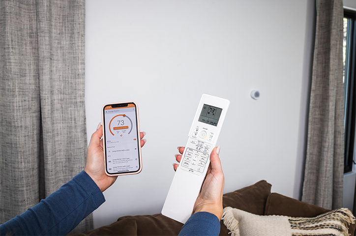 Flair App on iPhone next to Handheld Mini Split Remote with Puck 2 on the wall