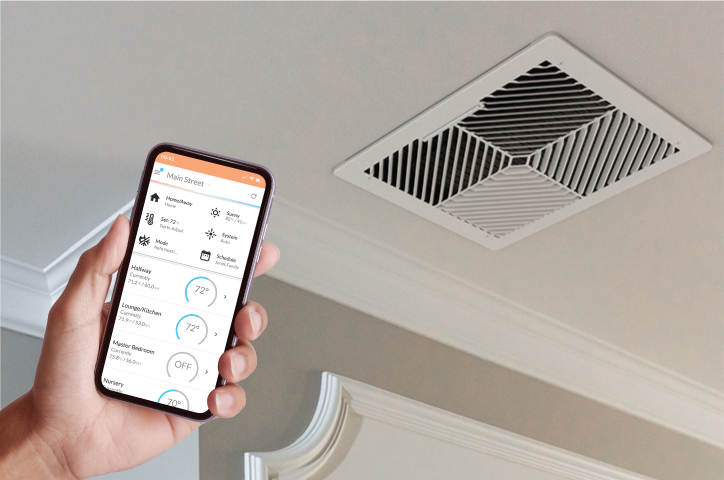 Flair Smart Vent installed in ceiling alongside Flair app on smartphone, showing home climate control screen.