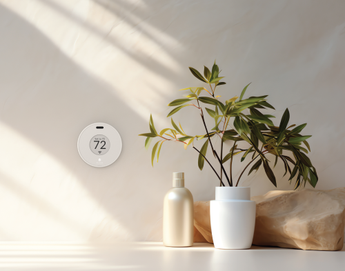 Flair Puck wireless thermostat mounted on a wall, used to control room temperature and airflow.
